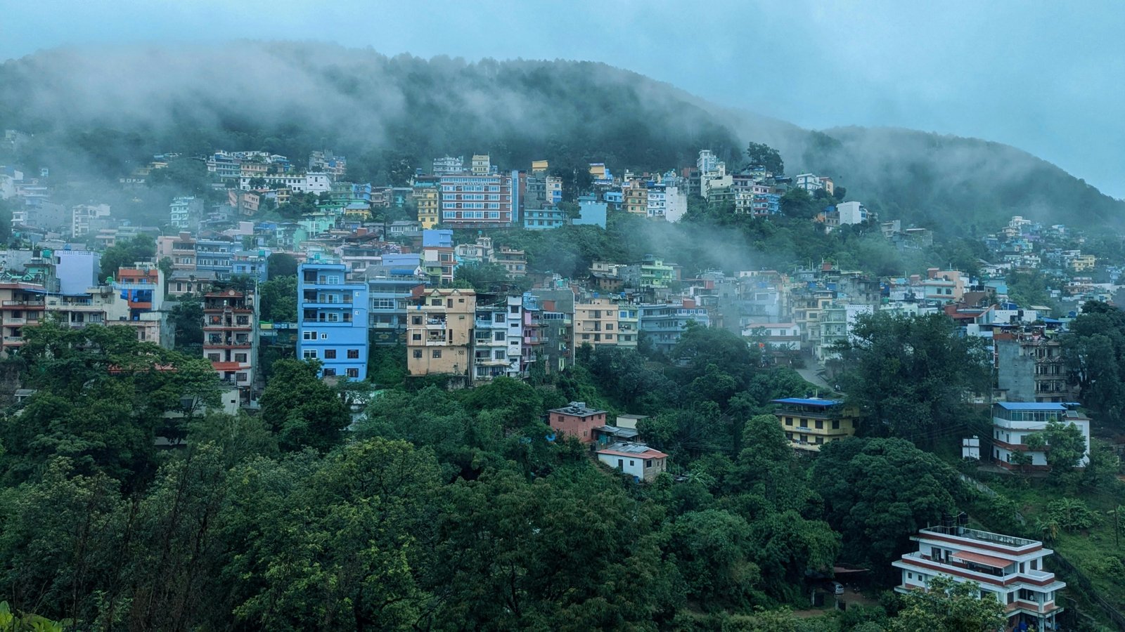 Discover the misty hills and colorful houses of Palpa Deurali, Nepal.